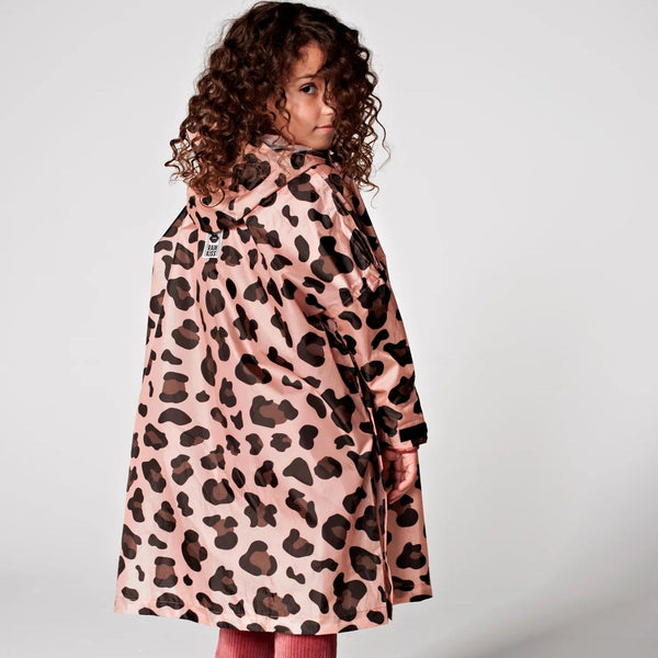 Child wearing a pink coat with a leopard print pattern on a white background