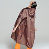 Person wearing a striped raincoat and orange pants on a plain background