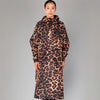 Person wearing a leopard print coat on a gray background