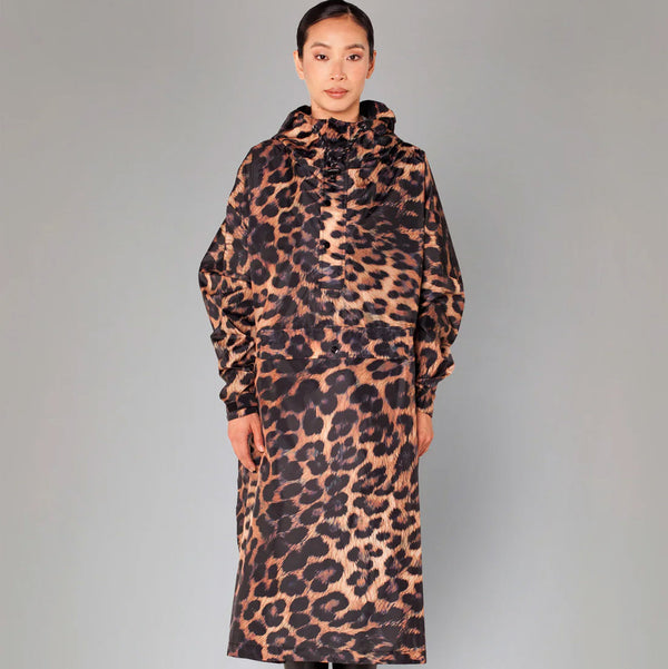 Person wearing a leopard print coat on a gray background