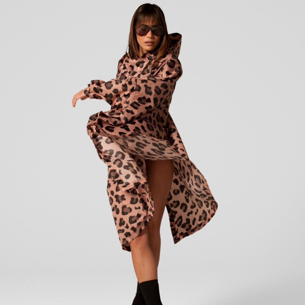 Woman wearing a leopard print dress on a white background
