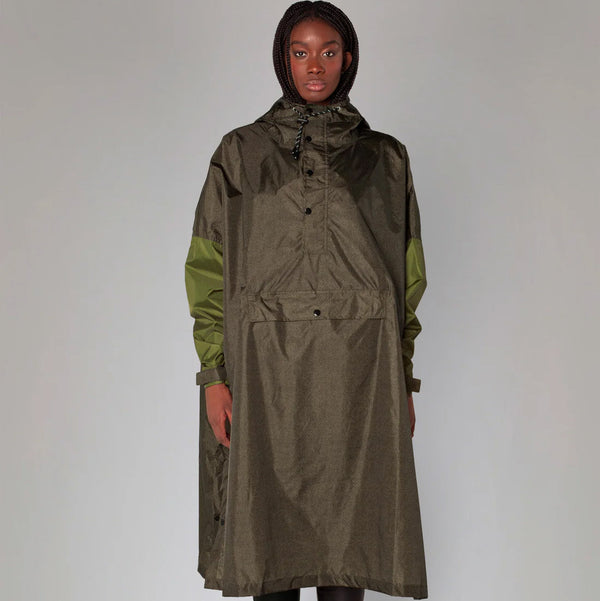 Person wearing a long green raincoat with a hood on a white background