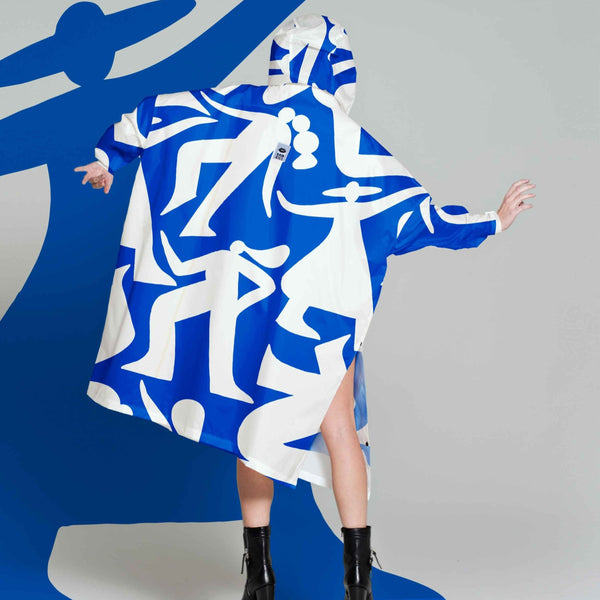 Person wearing a blue and white patterned dress with a large blue silhouette in the background.